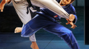 A man in blue and white fighting on the ground.
